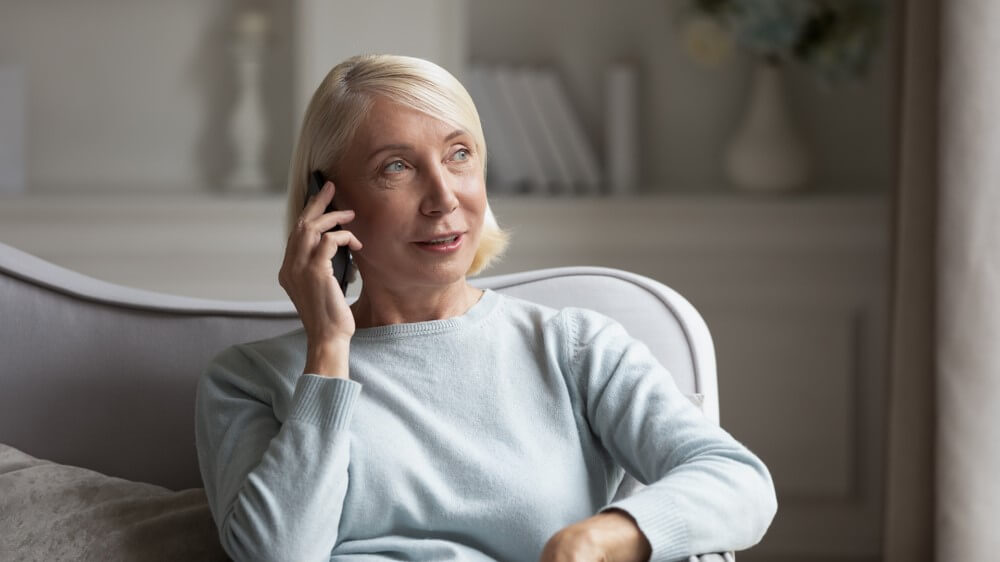 older woman conducting a phone interview